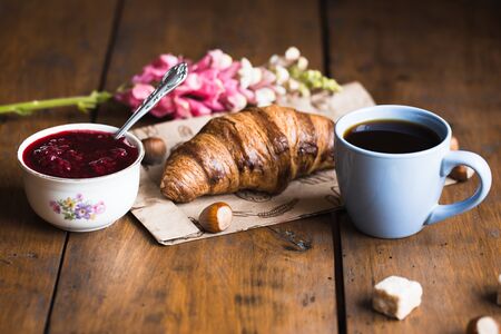 Coffee croissant on old wooden table backgroundの写真素材
