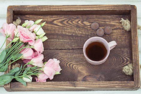 Cup of hot tea and pink eustoma flowers. Spring conceptの写真素材