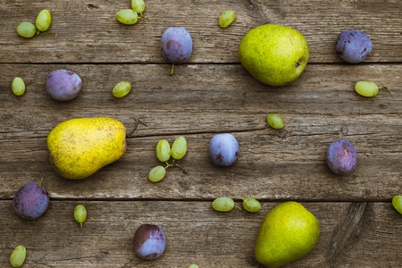 fruit grapes plum pear on wooden backgroundの写真素材