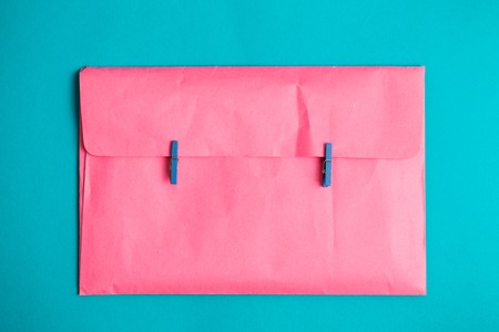 The pink envelope holds the clothespins. Minimalismの写真素材