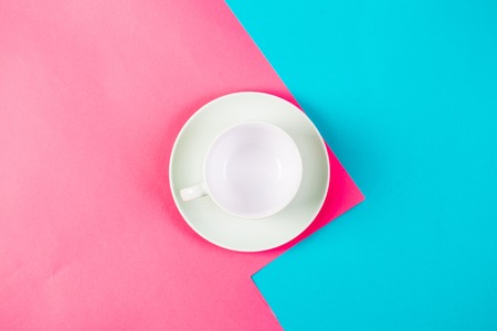 Empty cup on the yellow and blue background. Minimalism.の写真素材
