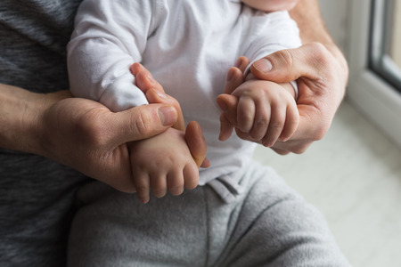 Father holding child handsの写真素材