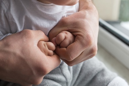 Father holding child handsの写真素材