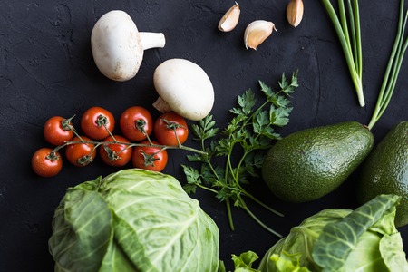 Fresh vegetables: cabbage, avocado, tomato, rosemary, garlic, mushrooms, leeksの写真素材