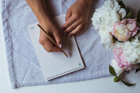 Notebook with bouquet peoniesの写真素材