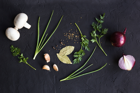 Garlic onion and parsley on a black backgroundの写真素材