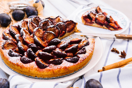 Homemade plum pie on the wooden backgroundの写真素材