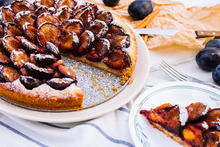 Homemade plum pie on the wooden backgroundの写真素材