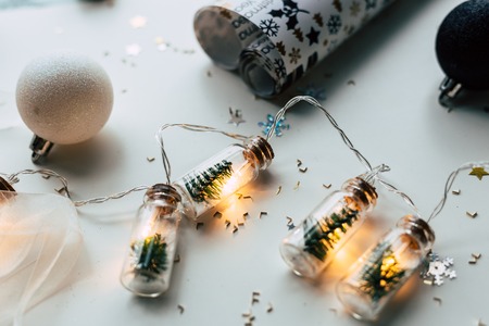 Christmas balls and christmas lights on a wooden surface.の写真素材