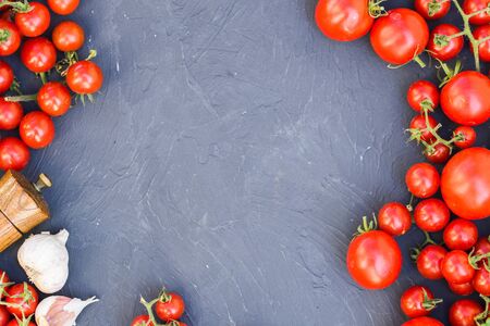 Fresh grape tomatoes with basil and garlic, pepper.の写真素材