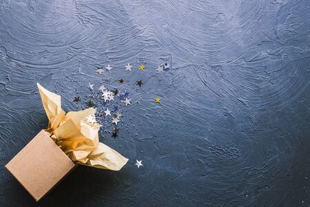 Open gift box with star on a black backround.