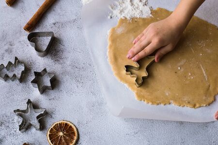 Cooking Christmas gingerbread cookies on a gray background.