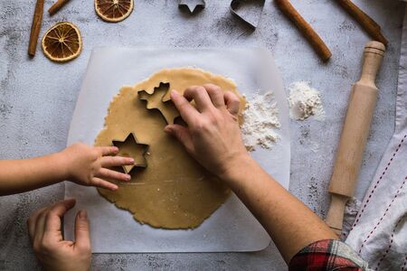 Cooking Christmas gingerbread cookies on a gray background.の写真素材