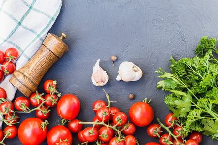 Fresh grape tomatoes with basil and garlic, pepper.の写真素材