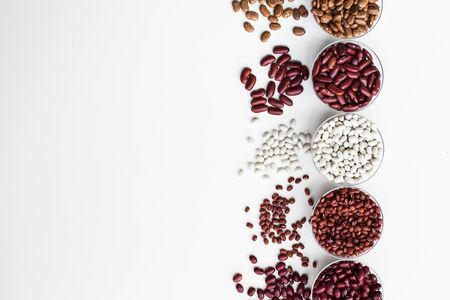 Different varieties of bean seeds on a white background.の写真素材