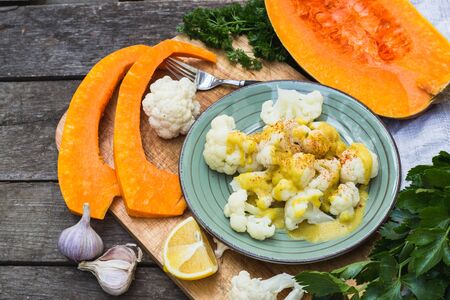 Steamed cauliflower with sauce and pumpkinの写真素材