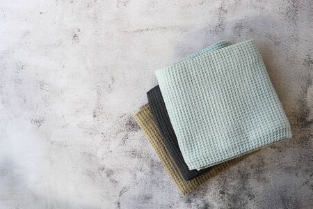 Stack kitchen cotton towels on gray background.の写真素材