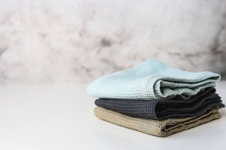 Stack kitchen cotton towels on gray background.の写真素材