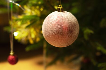 Christmas ball hanging on a branch close-up. with place for textの写真素材