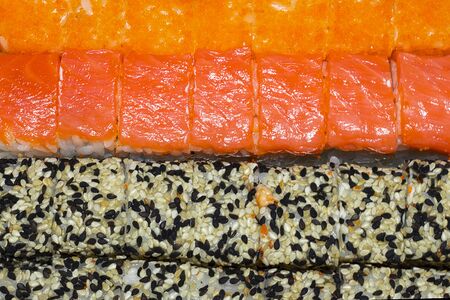 rolls laid out in rows. Salmon rolls and sesame rollsの写真素材