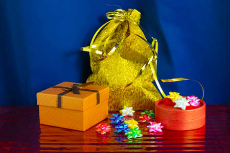 New years flatlay on a red background with a wreath for interior decoration,gift boxes, top view...