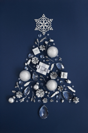 Luxury shape of New Year tree made of crystal and silver Christmas decorations on dark blue background. Holiday greeting card concept and Christmas symbol. Top view. の写真素材