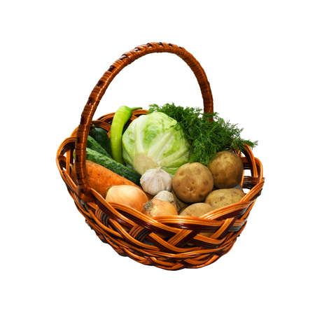 Basket with vegetables on white background. Fresh healthy food, a vegetarian diet including cabbage, fennel, green pepper, cucumbers, potatoes, carrot, onions and garlicsの写真素材