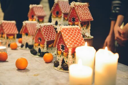 Gingerbread house making by hands. Christmas holiday.の写真素材