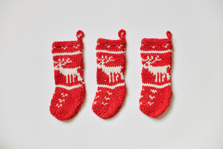 knitted christmas stockings with deer isolated on white backgroundの写真素材