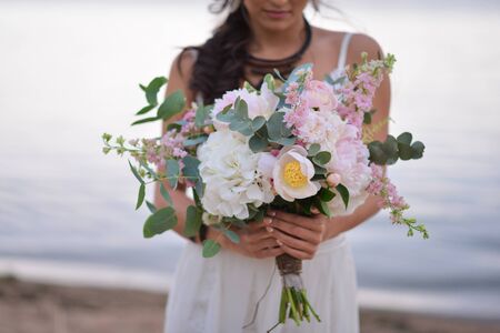 Bride holding her boho wedding bouquet.の写真素材