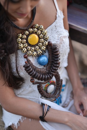 woman in white dress sitting on the beach. bride in Boho styleの写真素材