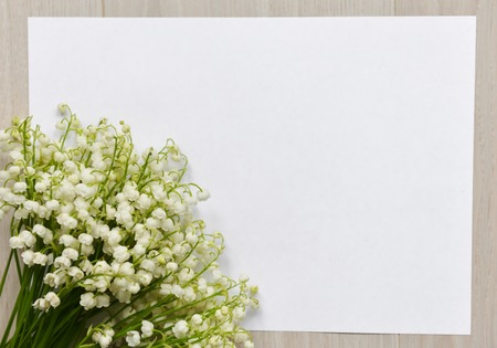 flowers lily of the valley stand on the table backgroundの写真素材