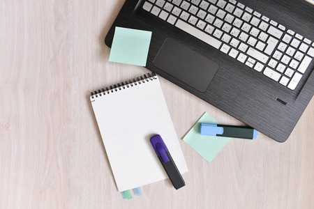 table with a laptop and blaknotom. A blank page for entering text in the middle.の写真素材