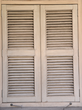 a row of old vintage windows on a street in the city.の写真素材