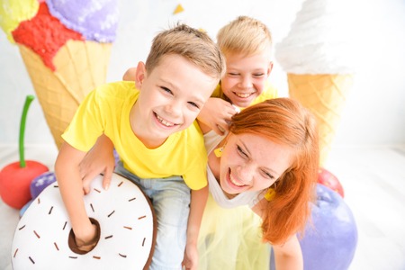 Candy Bar with Sweets. Cake, cookies, creamy muffins, fresh berries for celebratory birthday. birthday decorations. for a kids party. mother with sons, brothersの写真素材