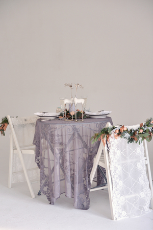 Christmas decor for table setting, or wedding decor, studio with a Christmas tree. Christmas decorations toys, candles, fir branchesの写真素材