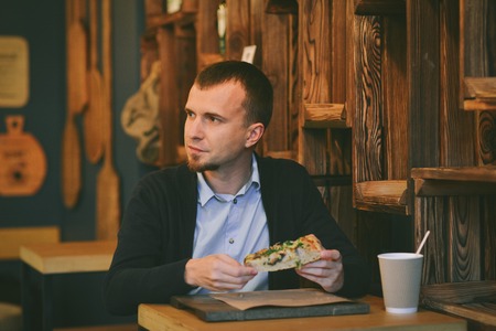 Portrait man drink coffee sitting in cafe.の写真素材