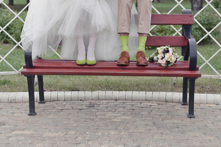 bridesmaid bridal shoes next to a bouquet of flowersの写真素材
