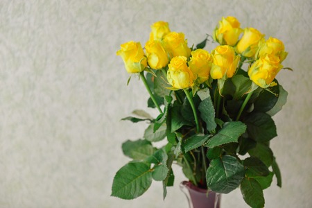 bouquet yellow roses on the table in a vase indoors. gift for the holiday of March 8, Valentines Day, birthdayの写真素材