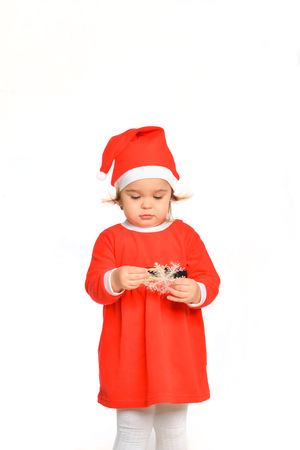 emotional kid girl in santa costume posing on white isolated background in new year holidayの写真素材