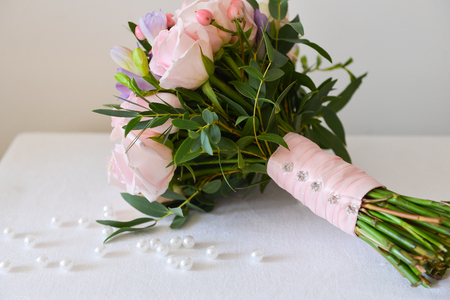 bridal bouquet of fresh roses on the table. wedding floristry, floristic decorative statementの写真素材