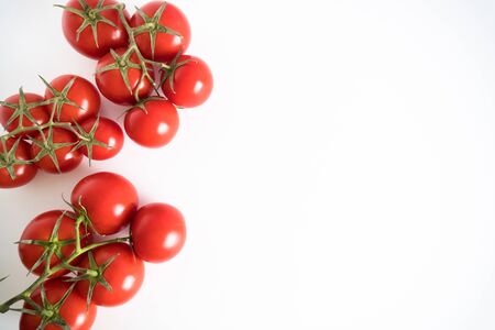 Group branch of a fresh red tomato cherry, isolated on a white backgroundの写真素材