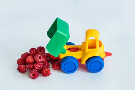 raspberries natural vitamins are in the back of truck in a childrens toy car food delivery truck...