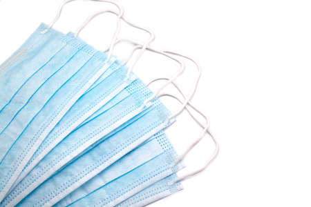 Medical protective blue masks on white background with drawn emotional eyes.