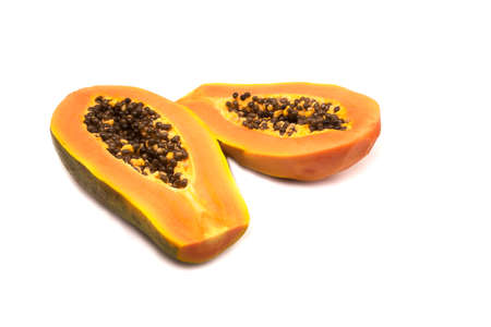 ripe papaya fruit with seeds isolated on white background.の写真素材