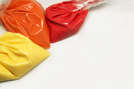 Colorful frosting. Variety of colors of royal icing in plastic piping bags.