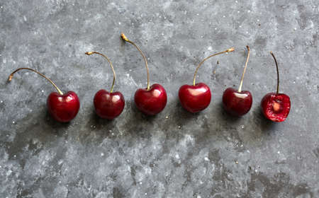 Fresh cherries on black background. Pattern of fruits.の写真素材
