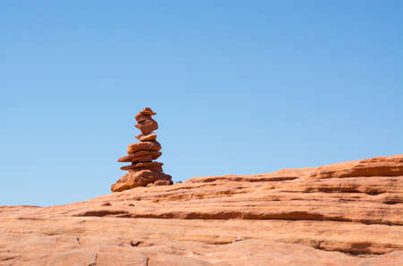 western landscape, stone pyramid made from red rocks in grand canyon with blue sky backgroundの写真素材