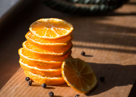 Dried sliced oranges on direct sun light, day light shot. Home decorationの写真素材