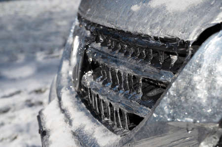 Frozen car with ice and snow. Freezing rain covered car.